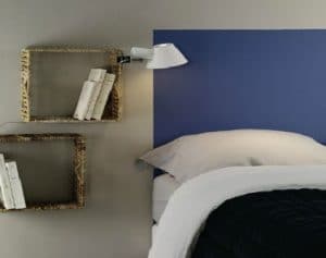 cabecero de color azul pintado directamente en la pared gris perla